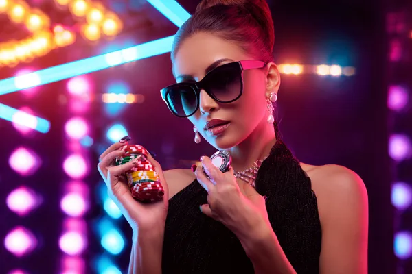 A young woman relaxing with her phone while dynamic casino elements float around her, illustrating the smooth mobile experience offered by the MC888C app.