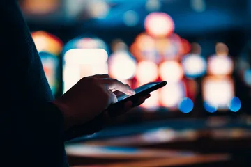 A stylish woman beside vibrant slot machines displaying glowing sevens, showcasing the variety of top slots at MC888C.