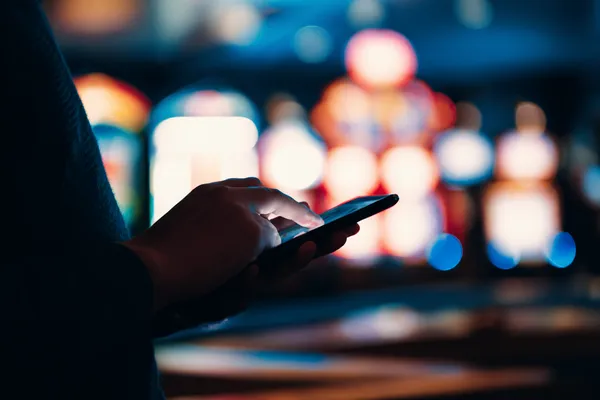 A stylish woman beside vibrant slot machines displaying glowing sevens, showcasing the variety of top slots at MC888C.