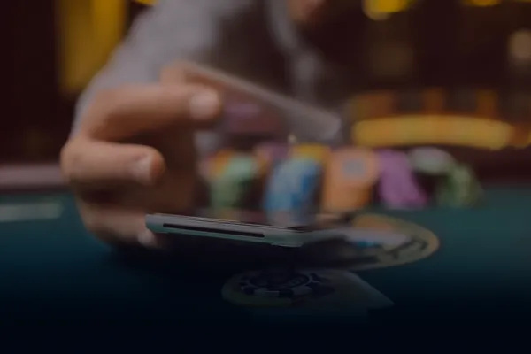 A person using their device against a moody casino-themed background, illustrating the smooth re-entry process at MC888C.